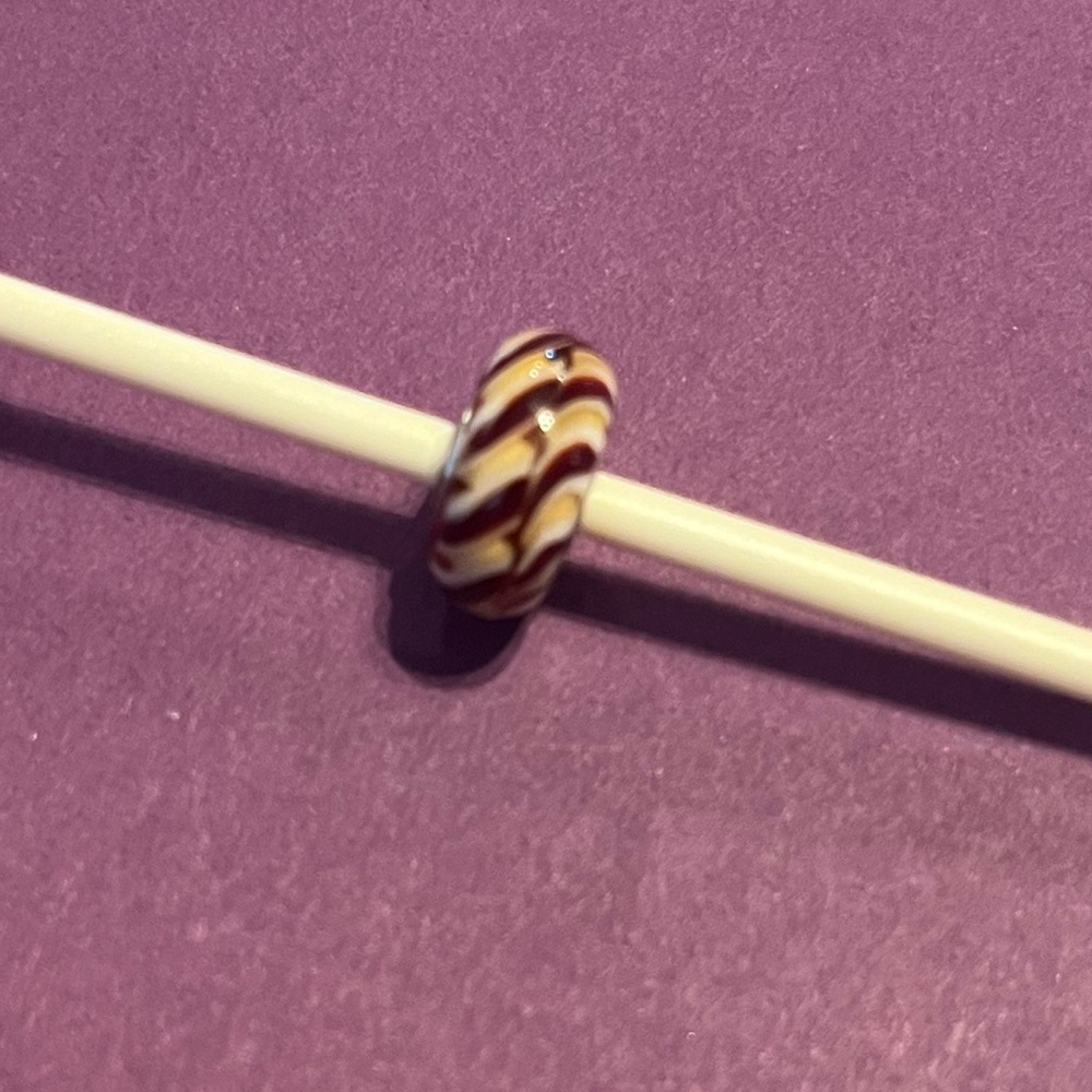 Trollbeads clear brown braid glass bead.